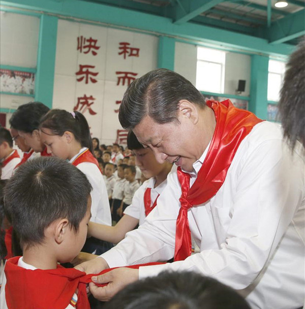 2014年5月30日，在北京市海澱區(qū)民族小學(xué)的少先隊入隊儀式上，習(xí)近平為新少先隊員繫上紅領(lǐng)巾。